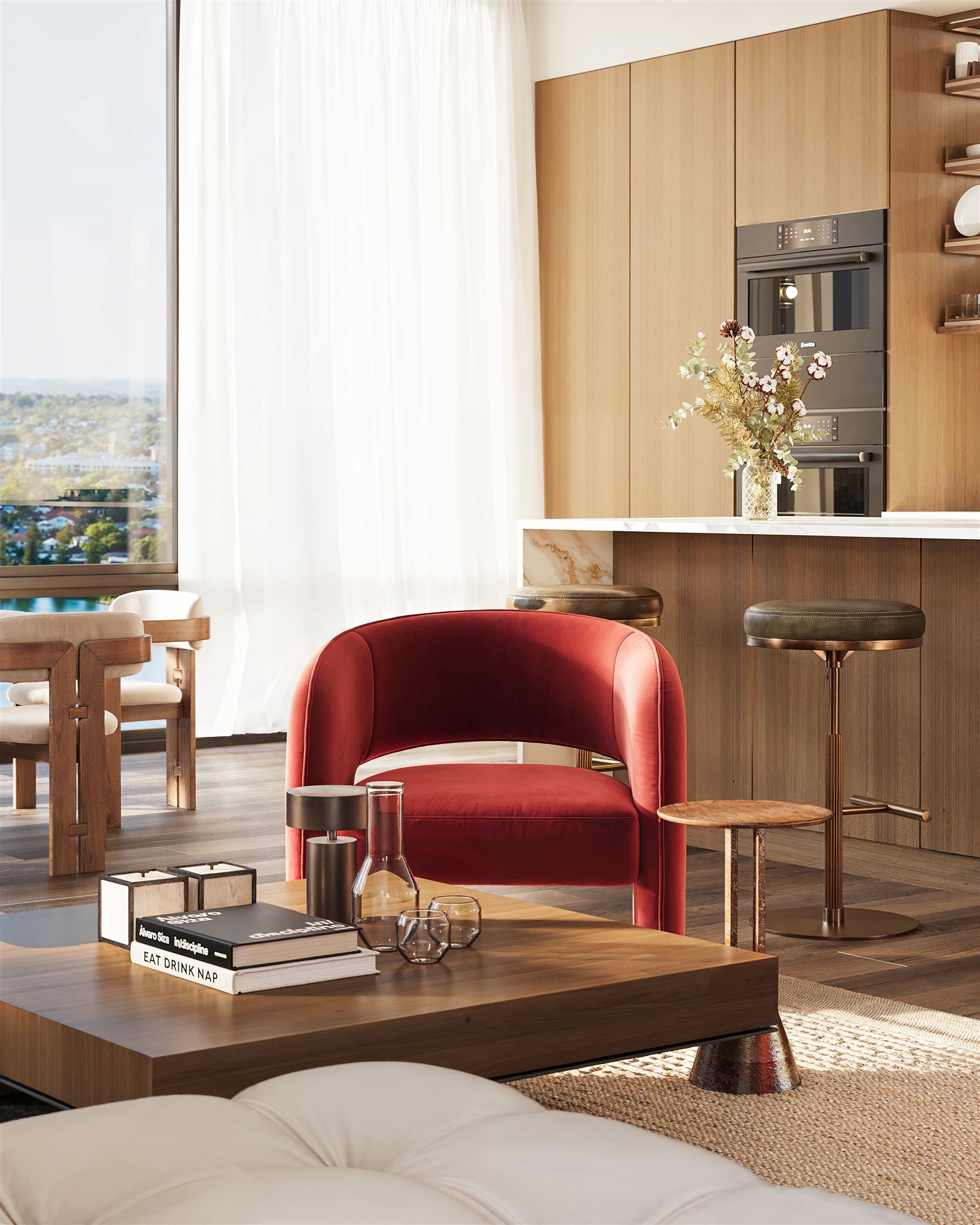 Red lounge chair beside an oak kitchen