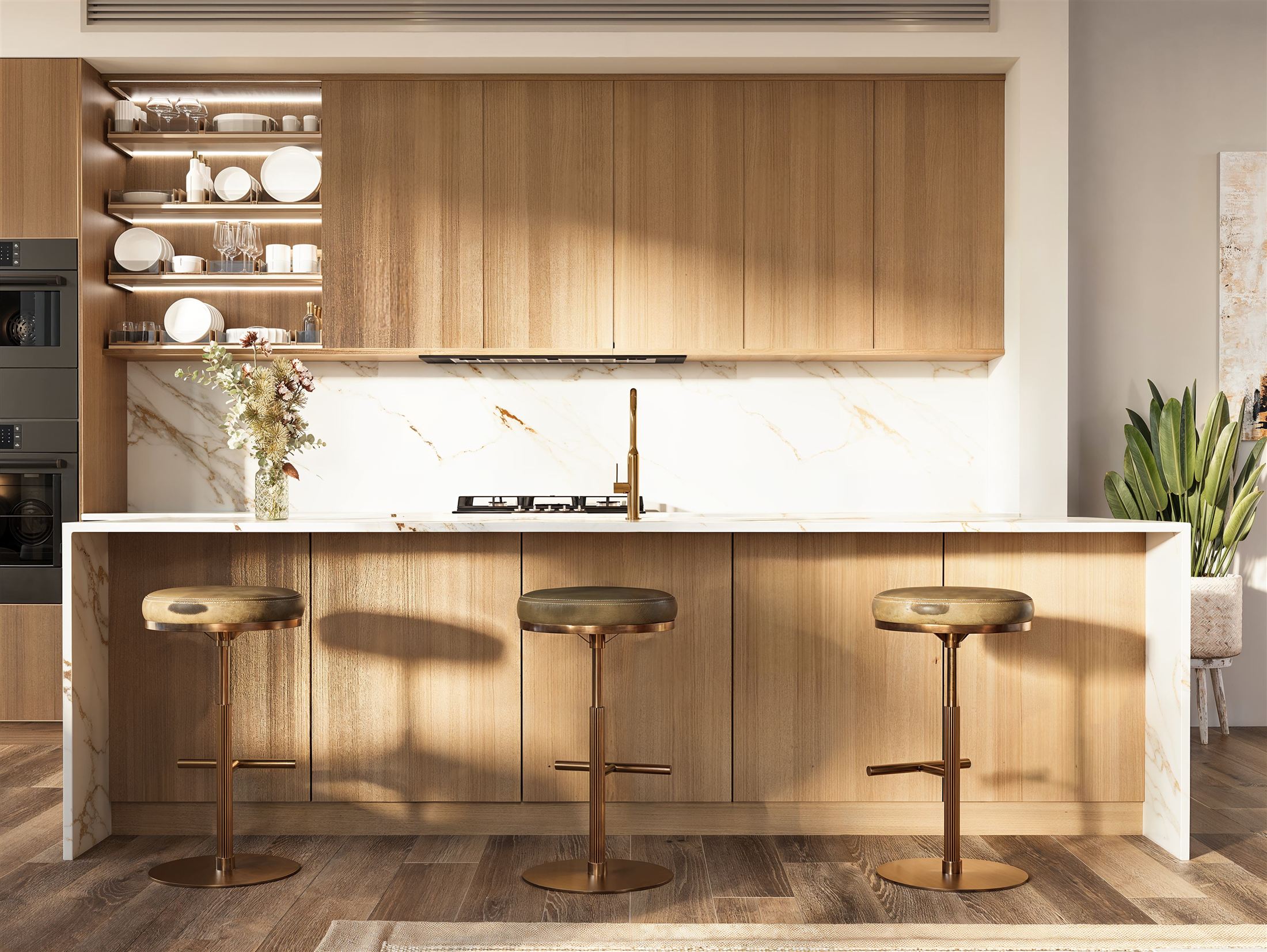 Oak kitchen with marble backsplash and brass stools