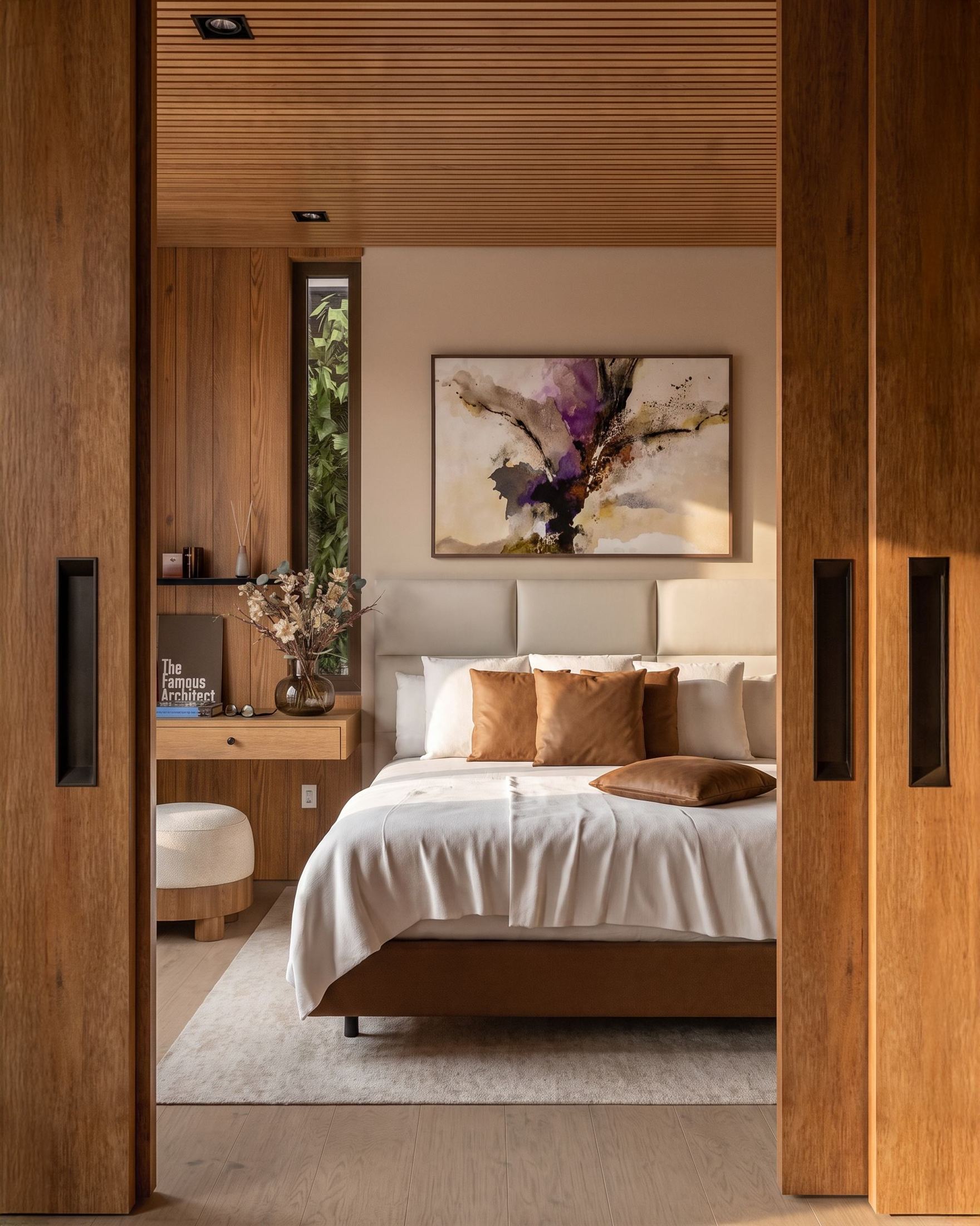 Primary suite seen through open walnut pocket doors